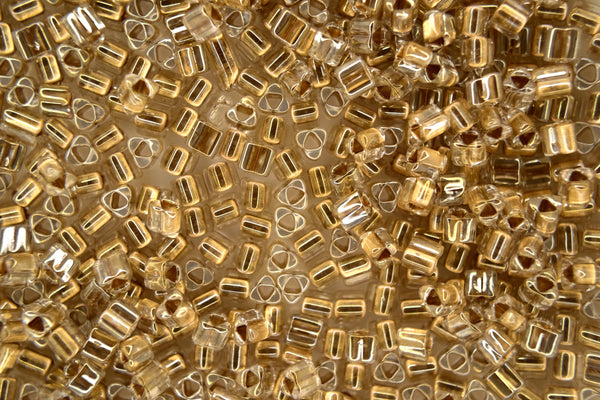 10g TOHO 8/0 Dreieck japanische Rocailles 3mm 989 Golden Lined Crystal